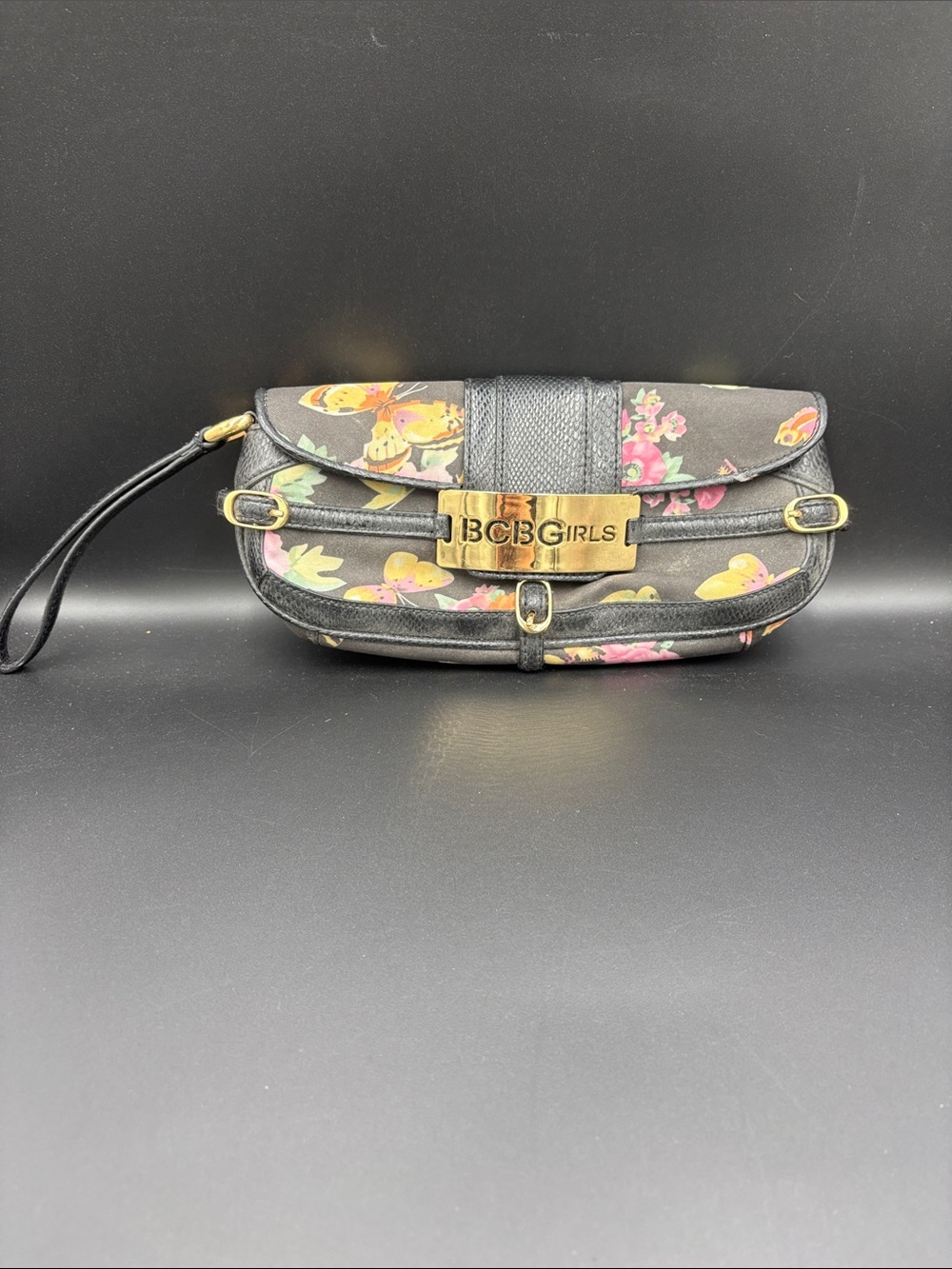 BCBGirls Black Floral and Butterfly Wristlet with Gold Logo Plaque
